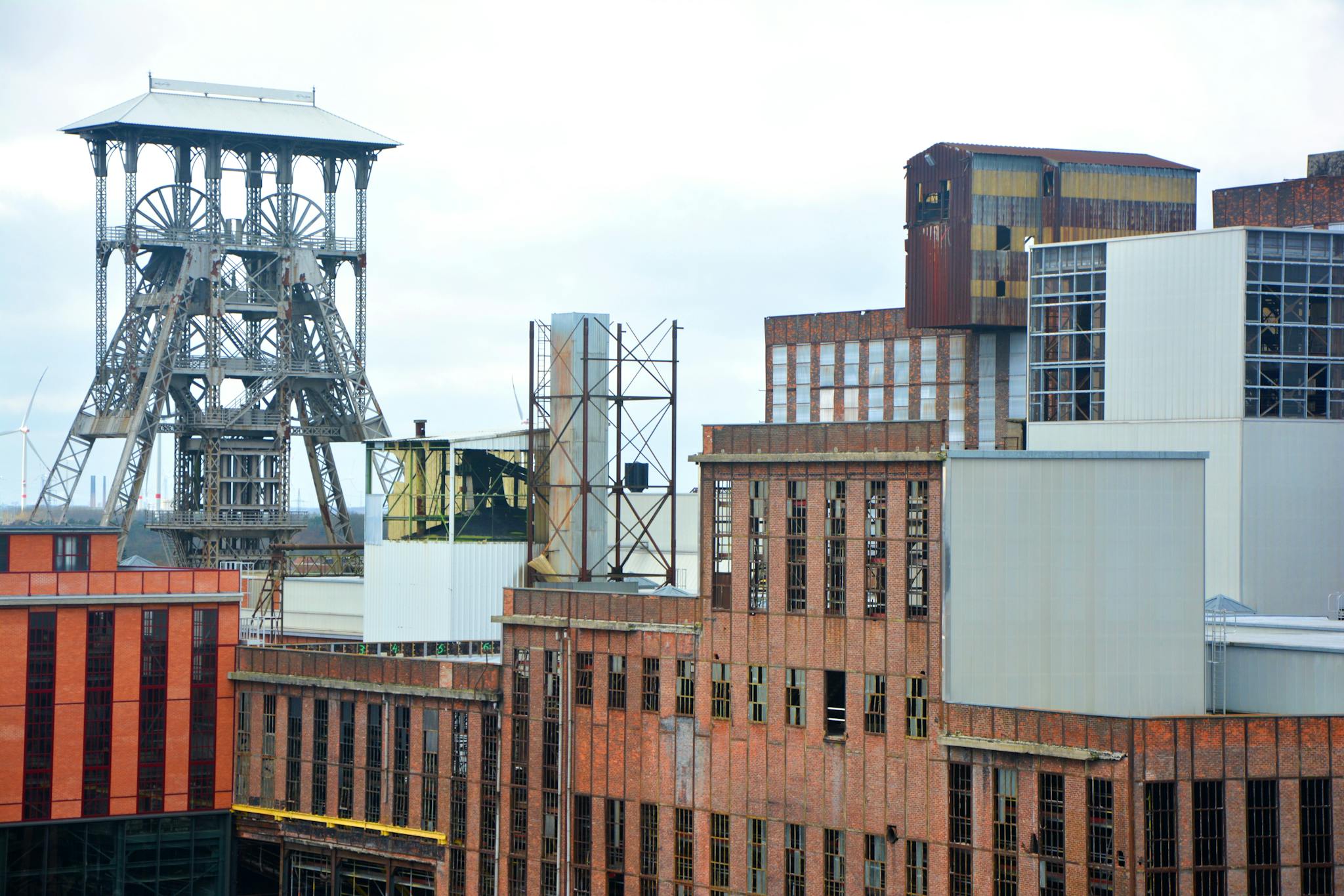 A detailed view of an old industrial complex with distinctive steel architecture and brickwork.