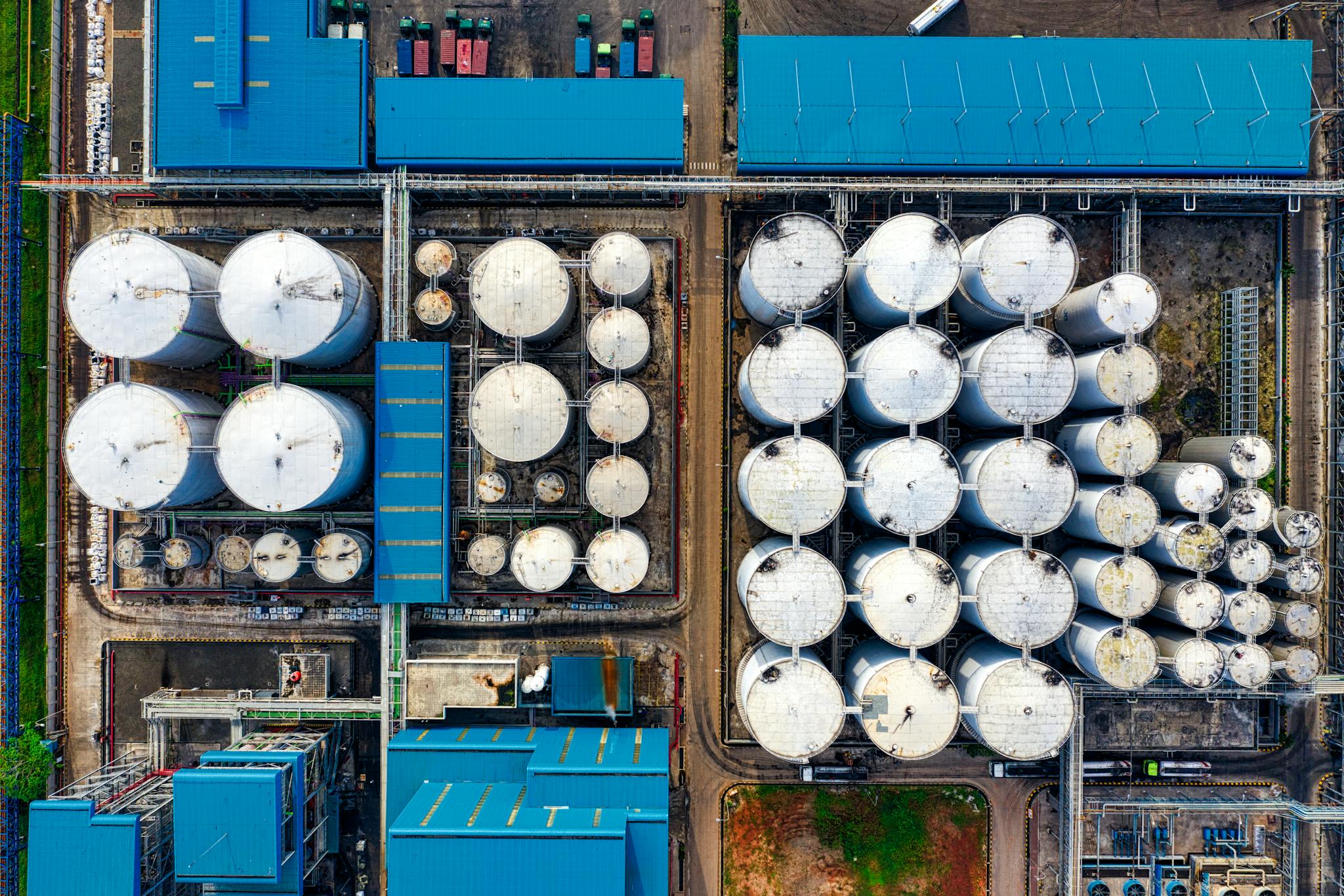High-angle view of modern industrial plant with storage tanks and buildings.
